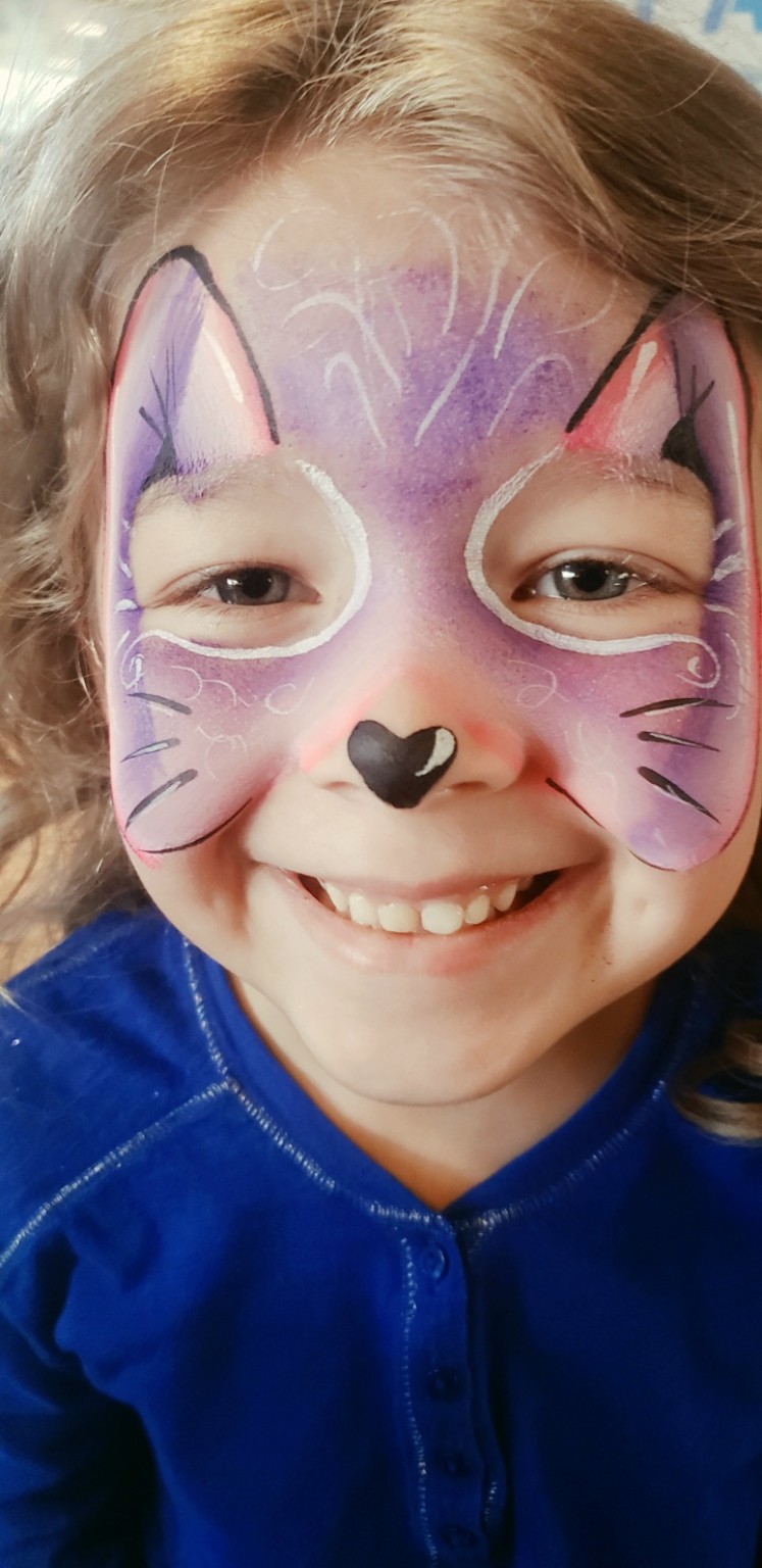 Purple cat face painting for a child